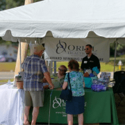 Oriol Home Health team members welcome visitors at the Oriol Health Care booth during Holden Days 2025 in Holden, MA, sharing resources and connecting with the community.