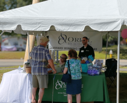 Oriol Home Health team members welcome visitors at the Oriol Health Care booth during Holden Days 2025 in Holden, MA, sharing resources and connecting with the community.