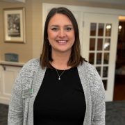 Logan Woodcome, Director of Social Services at Holden Rehabilitation & Skilled Nursing Center, smiling in a professional setting. Recognized as Oriol Health Care’s October 2025 Employee of the Month for her dedication and teamwork.