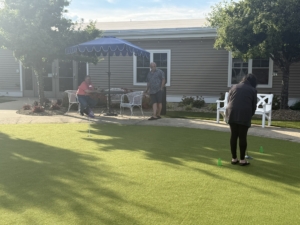 Holden Putting Green Resident and community members participate in a friendly putting challenge during Swing Into Wellness at Holden Rehabilitation & Skilled Nursing Center.